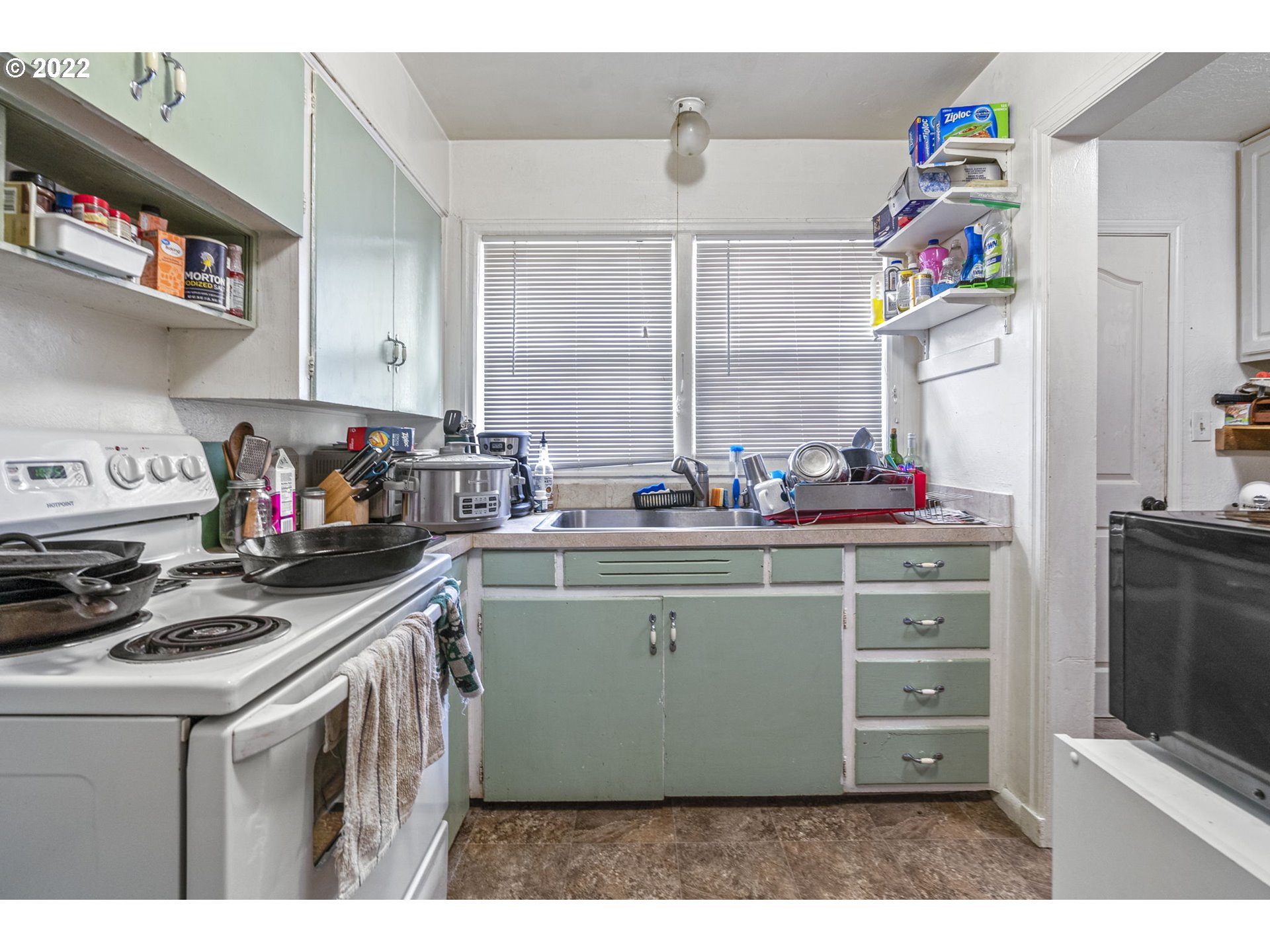 1057 17th Avenue Longview, WA 98632 - Photo 25 of 30 a kitchen with stainless steel appliances granite countertop a sink stove and cabinets