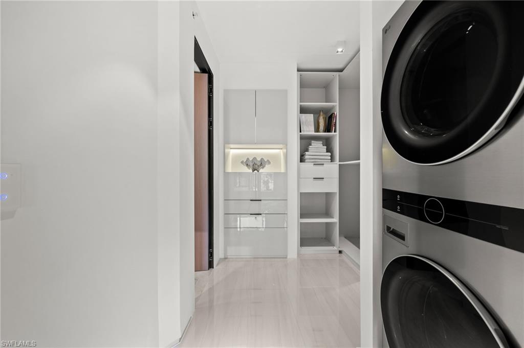 1100 Pine Ridge Road, Unit B103 Naples, FL 34108 - Photo 23 of 38 a view of a hallway with washer and dryer