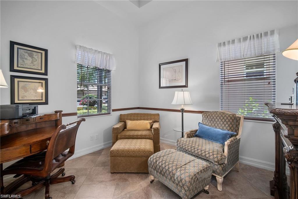 6476 Caldecott Drive Naples, FL 34113 - Photo 13 of 27 a living room with furniture and a window