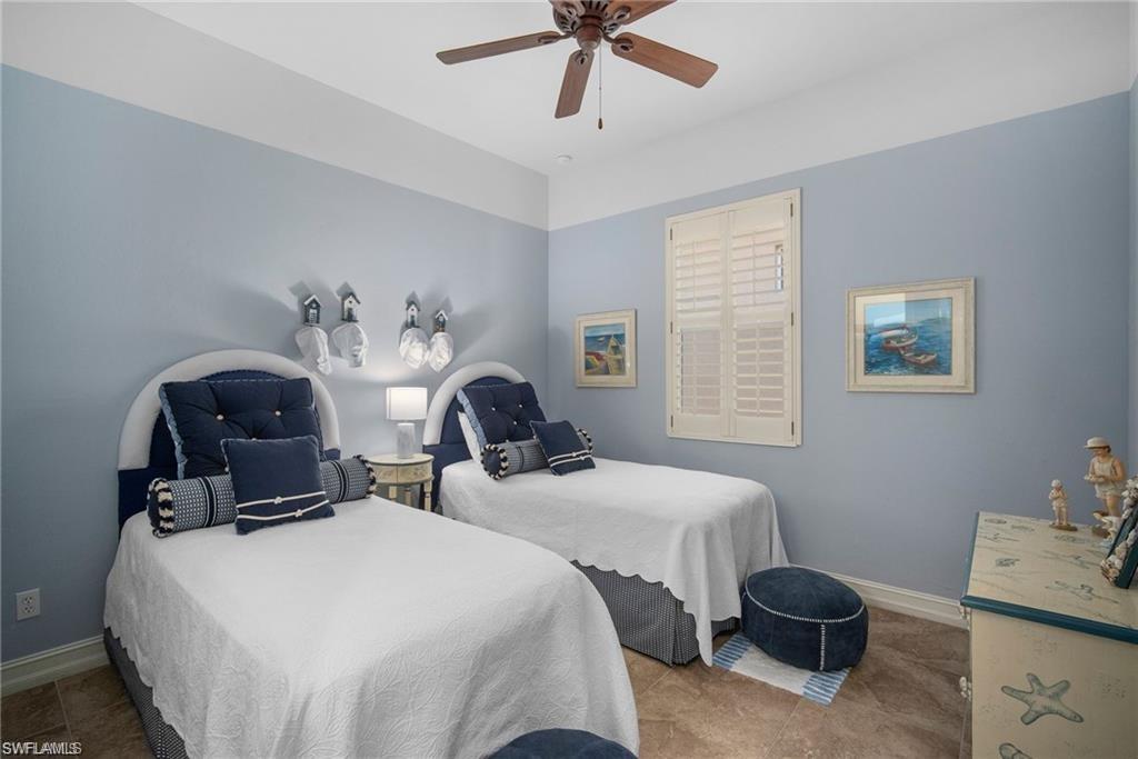 6476 Caldecott Drive Naples, FL 34113 - Photo 20 of 27 a bedroom with two beds and painting on the wall