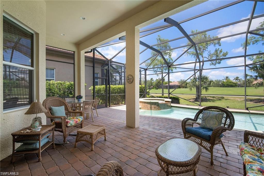 6476 Caldecott Drive Naples, FL 34113 - Photo 23 of 27 a patio with yard table and chairs