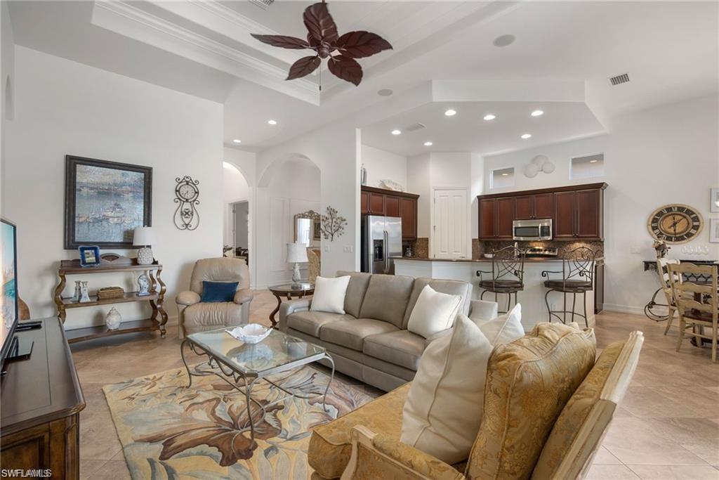 6476 Caldecott Drive Naples, FL 34113 - Photo 4 of 27 a living room with furniture and a flat screen tv