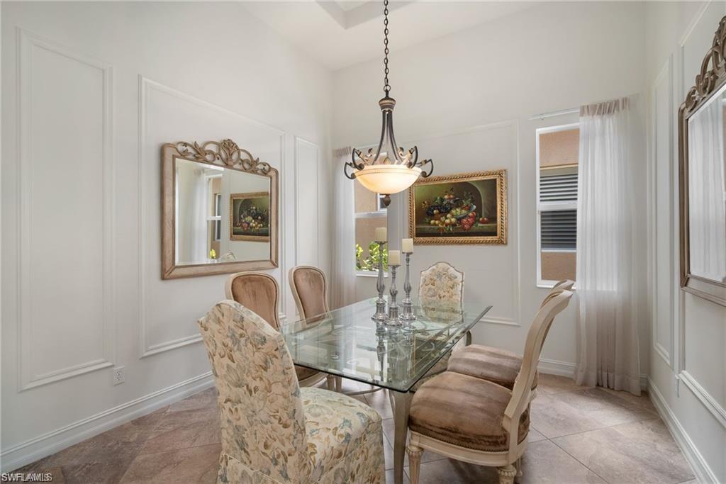 6476 Caldecott Drive Naples, FL 34113 - Photo 9 of 27 a dining room with furniture and chandelier