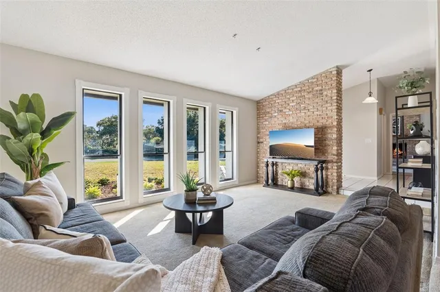 a living room with furniture and a large window with balcony view