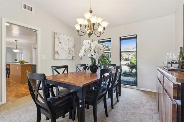 a view of a dining room with furniture and chandelier