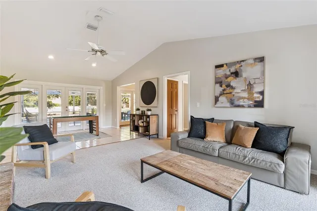 a living room with furniture and view of kitchen