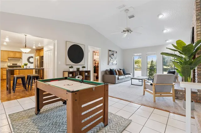 a living room with furniture a dining table and paintings on the wall