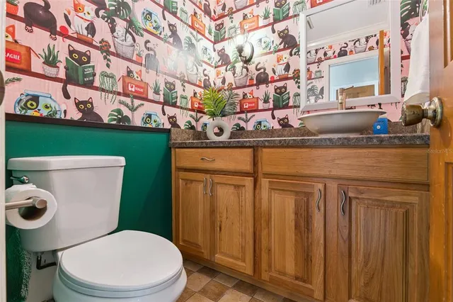 a bathroom with a toilet sink and mirror