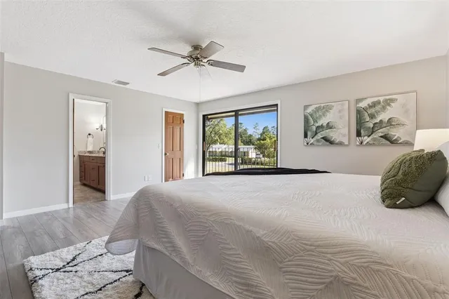 a bedroom with a bed and a painting on the wall
