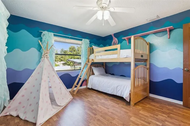 a bedroom with a large bed and a chandelier