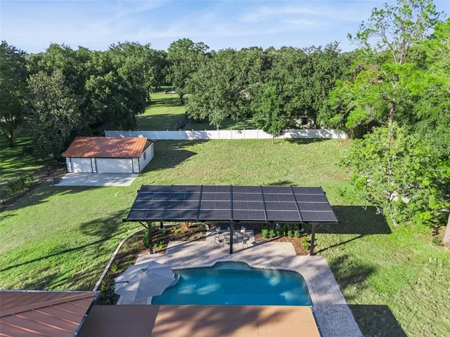 an aerial view of a chairs and table on the wooden floor