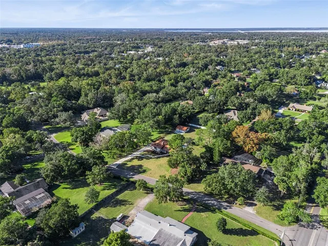an aerial view of a houses with a yard