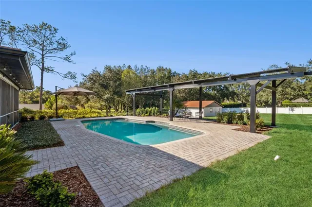 a view of a swimming pool with a patio