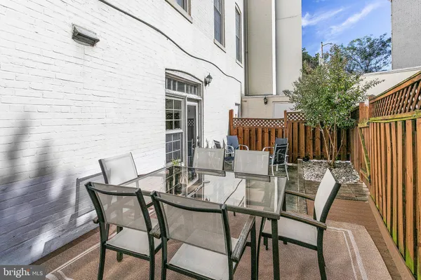 a view of a patio with a table and chairs