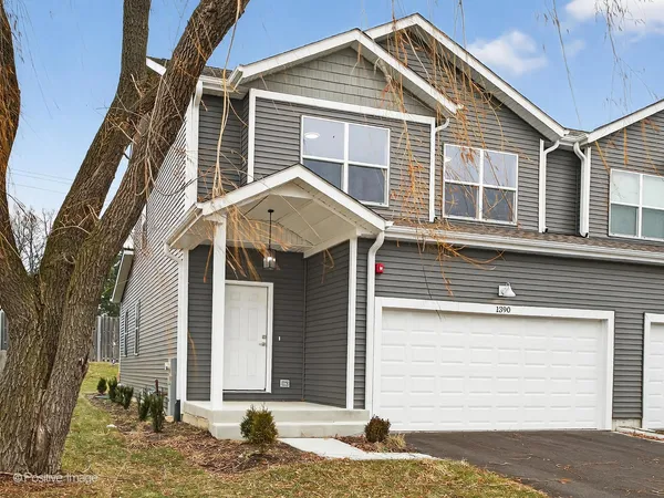 a front view of a house with a garage