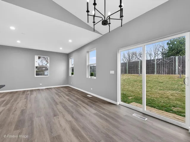 a view of kitchen with stainless steel appliances refrigerator stove microwave and cabinets