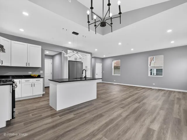 a kitchen with stainless steel appliances granite countertop a sink and a stove