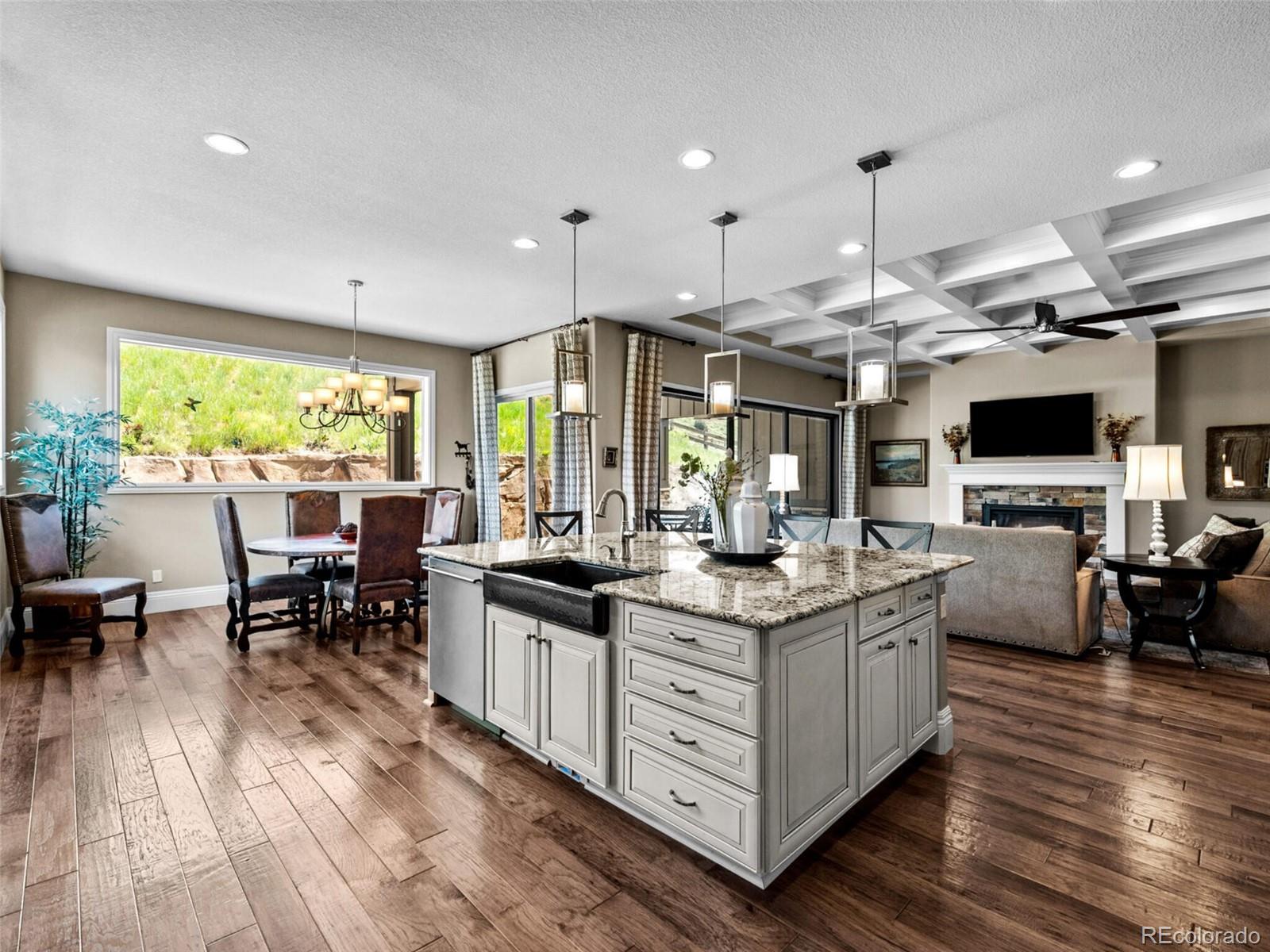 14945 Lyons Ridge Drive Morrison, CO 80465 - Photo 11 of 40 a large kitchen with stainless steel appliances lots of counter space and breakfast area