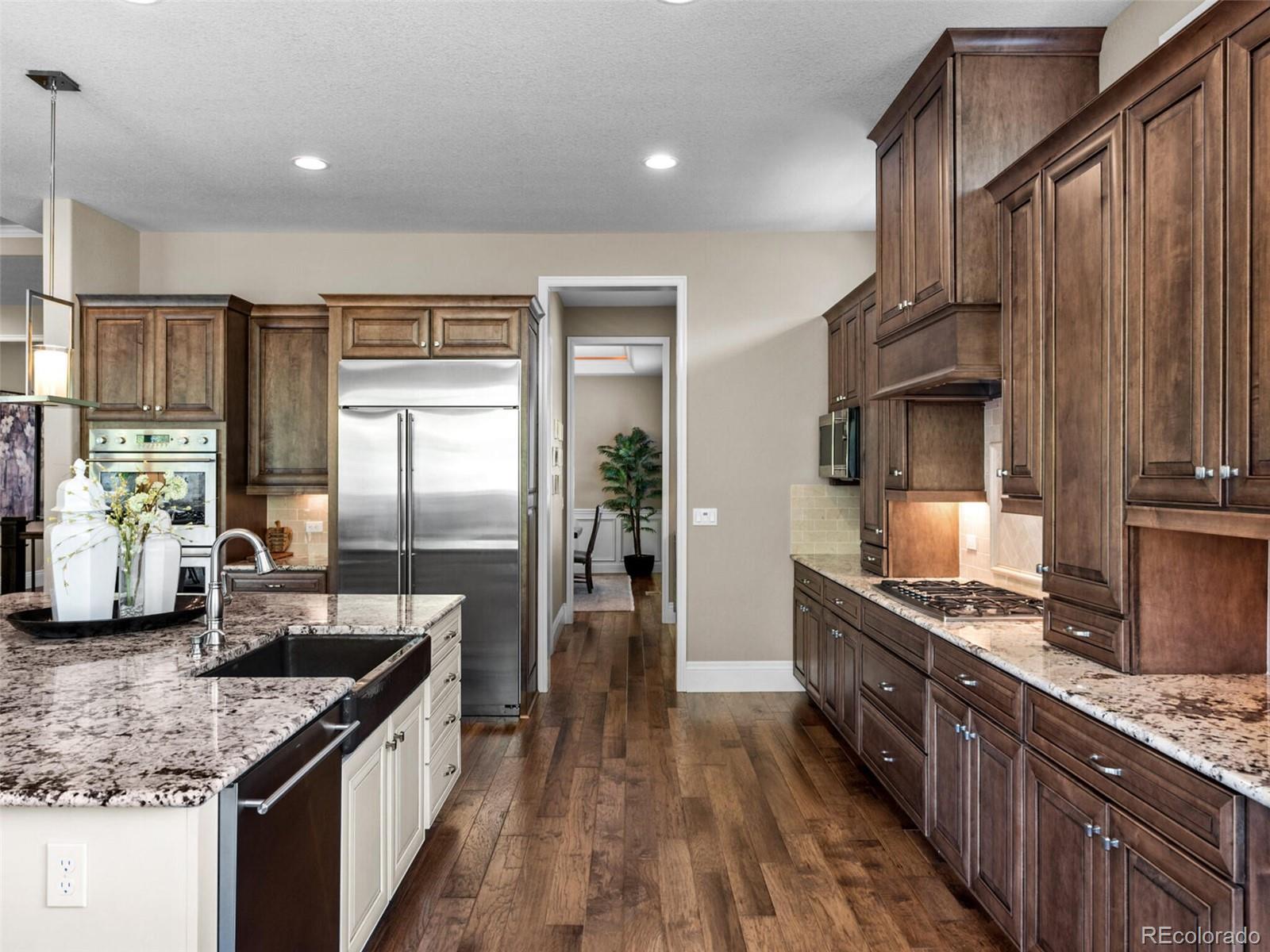 14945 Lyons Ridge Drive Morrison, CO 80465 - Photo 12 of 40 a kitchen with stainless steel appliances granite countertop a sink a stove and a refrigerator