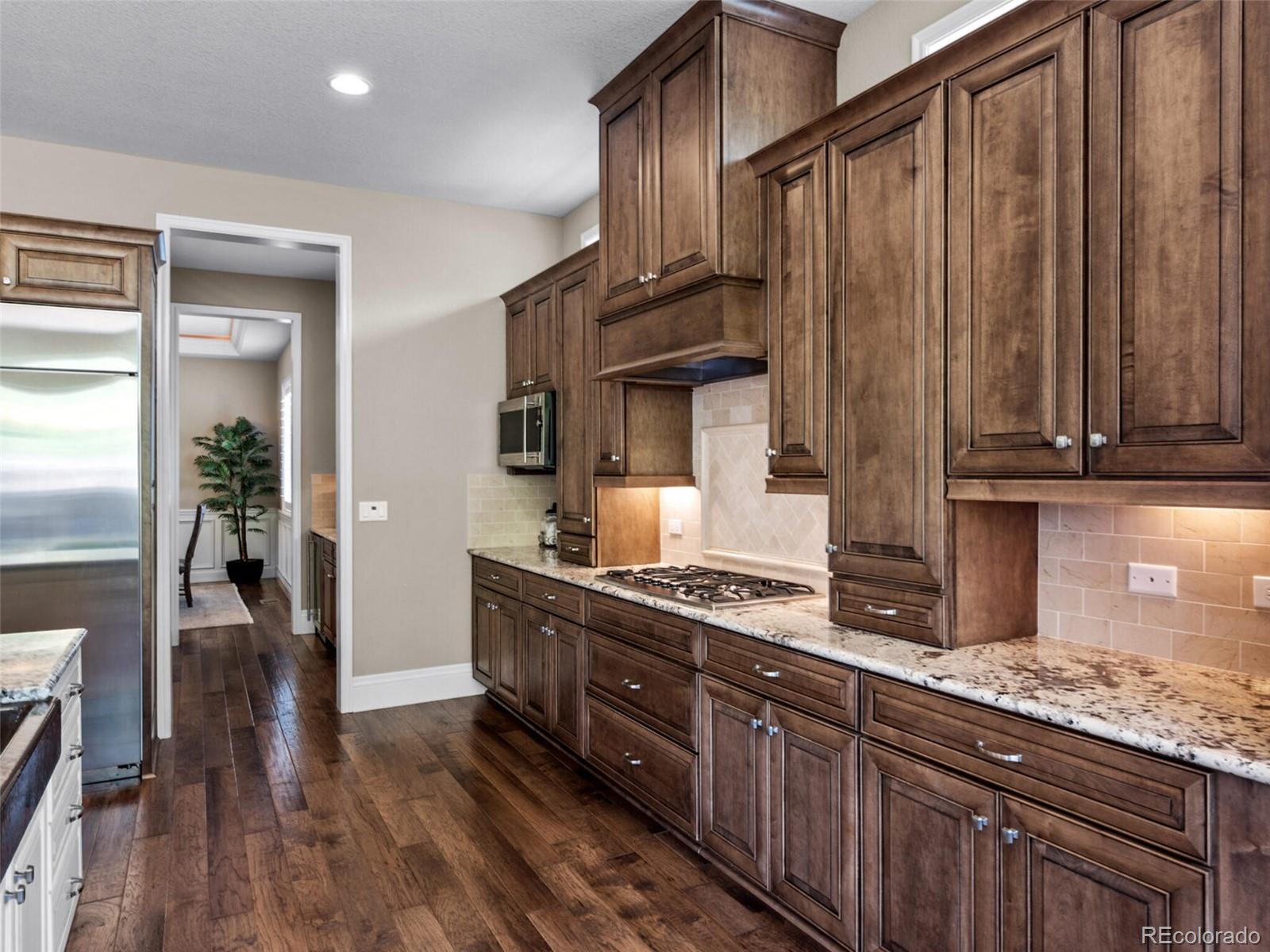 14945 Lyons Ridge Drive Morrison, CO 80465 - Photo 13 of 40 a kitchen with stainless steel appliances granite countertop a stove a sink and a refrigerator