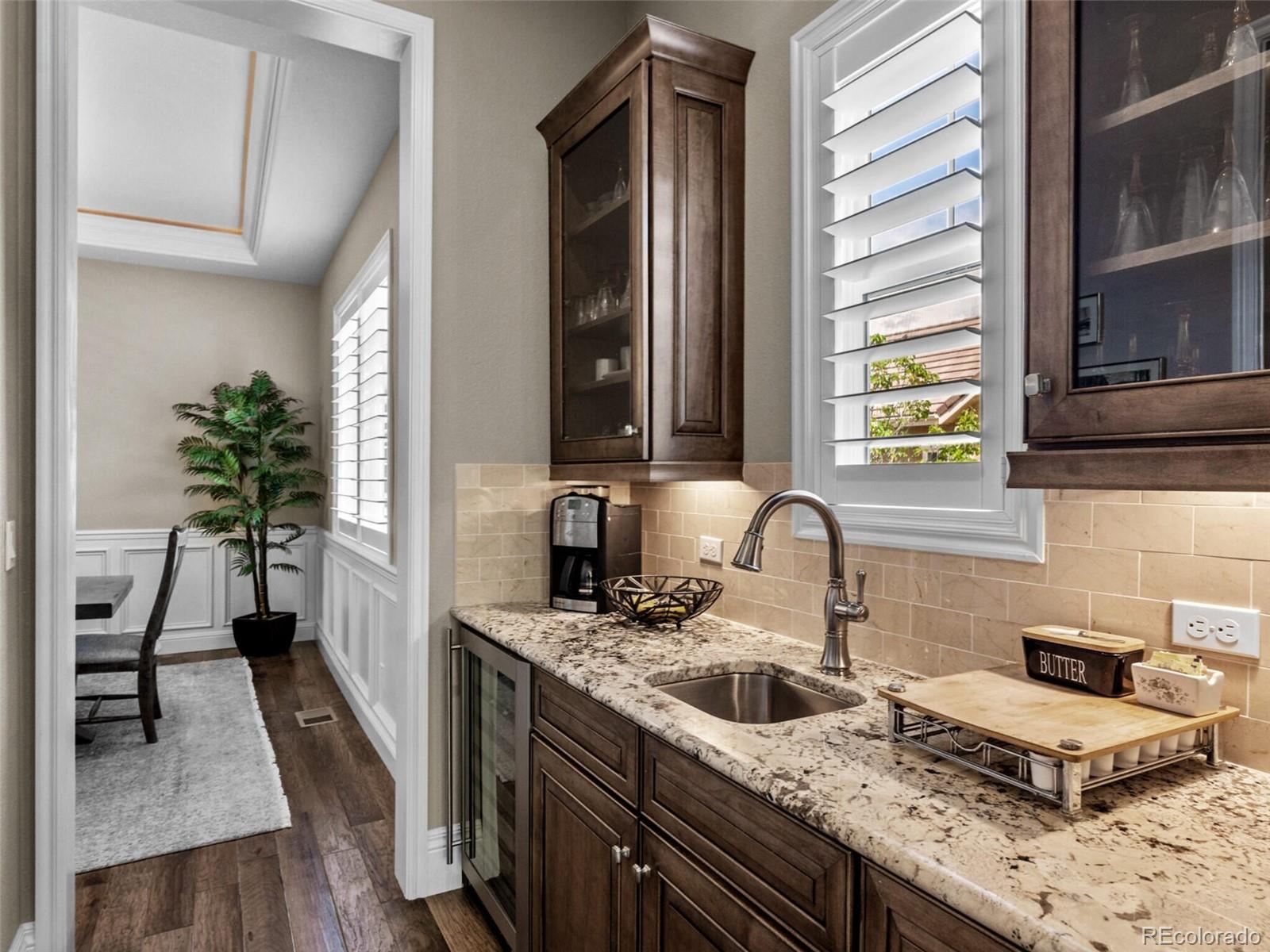 14945 Lyons Ridge Drive Morrison, CO 80465 - Photo 14 of 40 a kitchen with granite countertop a sink stove and cabinets