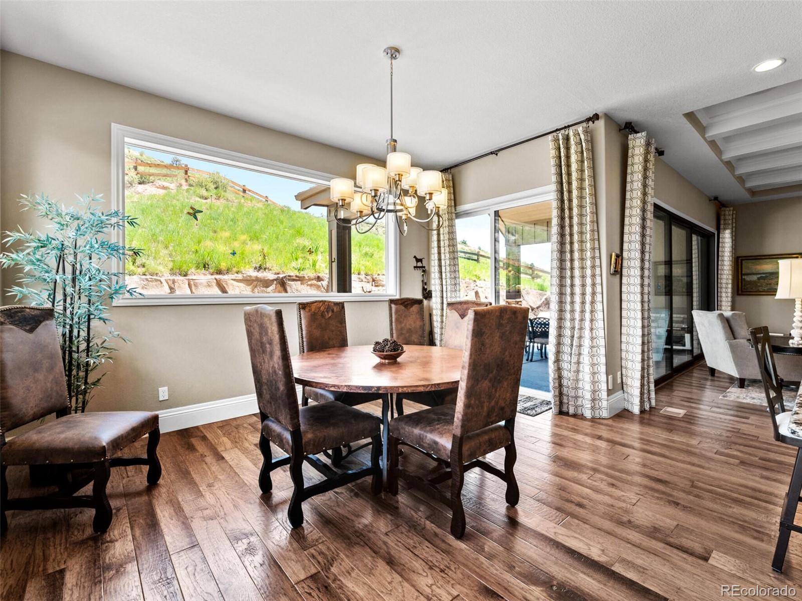 14945 Lyons Ridge Drive Morrison, CO 80465 - Photo 15 of 40 a view of a dining room with furniture window and wooden floor