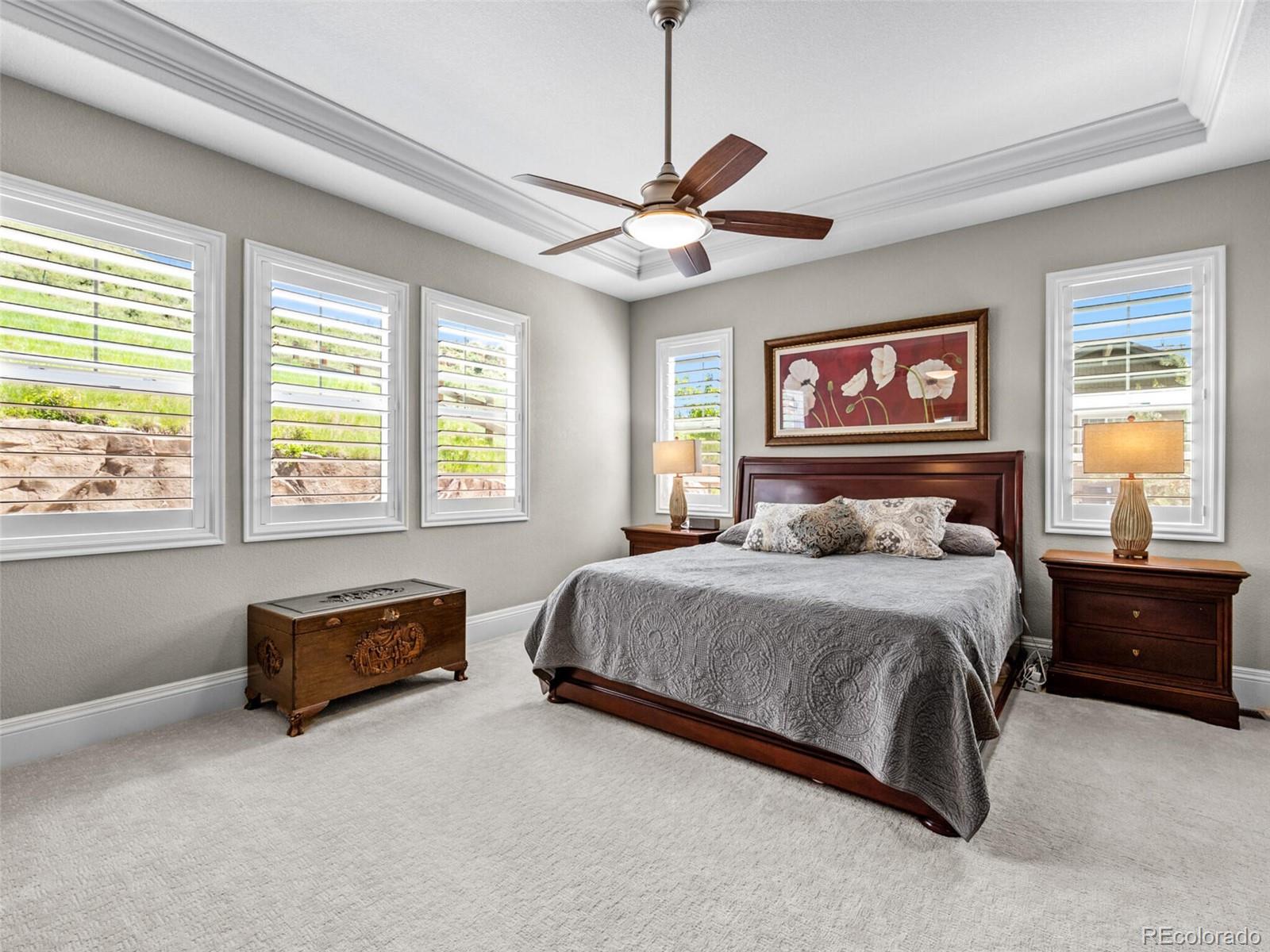 14945 Lyons Ridge Drive Morrison, CO 80465 - Photo 16 of 40 a bedroom with a bed dresser and a window