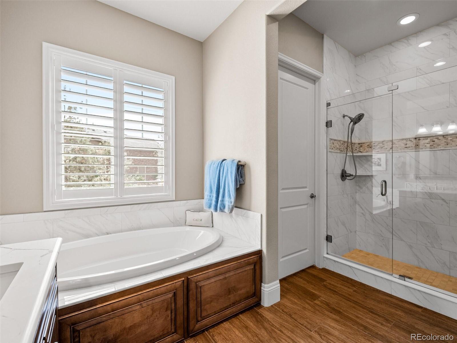14945 Lyons Ridge Drive Morrison, CO 80465 - Photo 18 of 40 a bathroom with a tub shower and sink