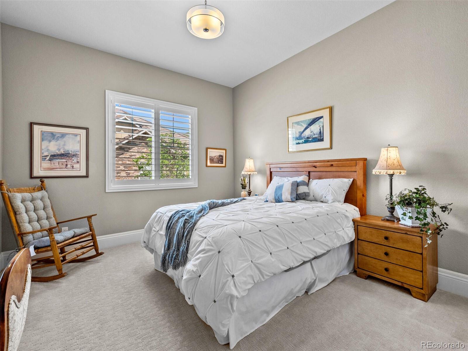 14945 Lyons Ridge Drive Morrison, CO 80465 - Photo 21 of 40 a bedroom with a bed and a couch