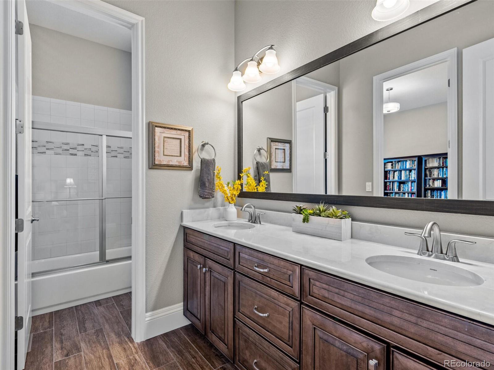14945 Lyons Ridge Drive Morrison, CO 80465 - Photo 22 of 40 a bathroom with a sink and a mirror