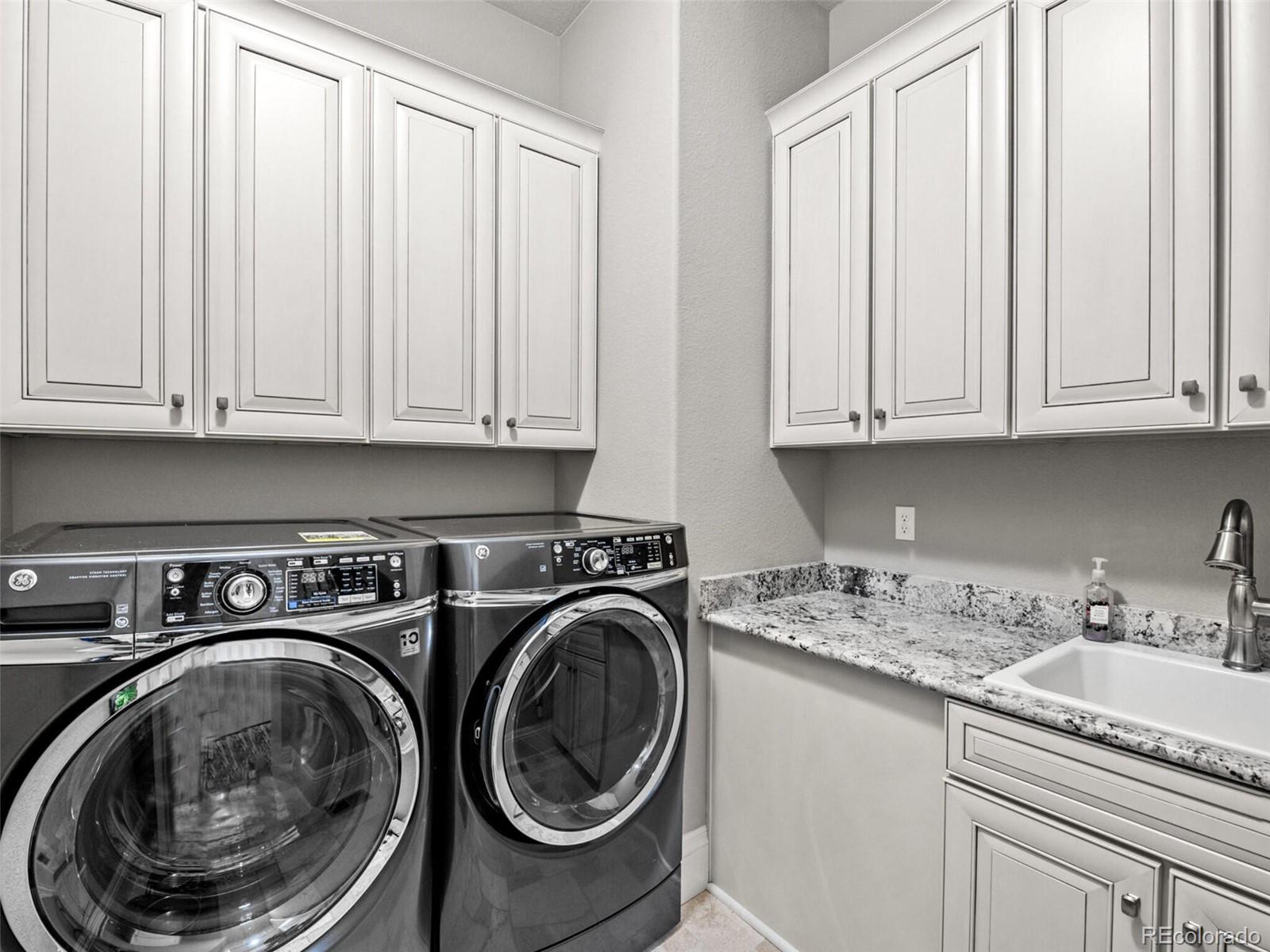 14945 Lyons Ridge Drive Morrison, CO 80465 - Photo 25 of 40 a utility room with sink dryer and washer