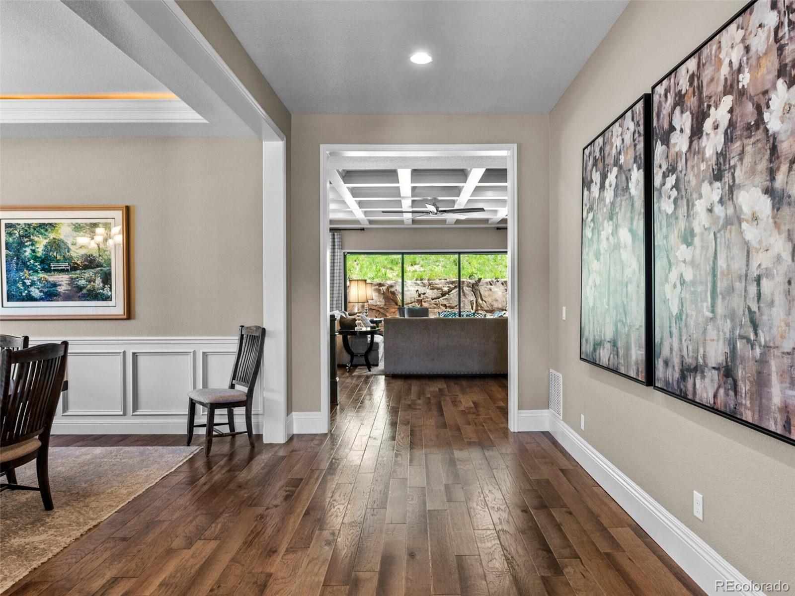 14945 Lyons Ridge Drive Morrison, CO 80465 - Photo 3 of 40 a view of a dining room with furniture and wooden floor