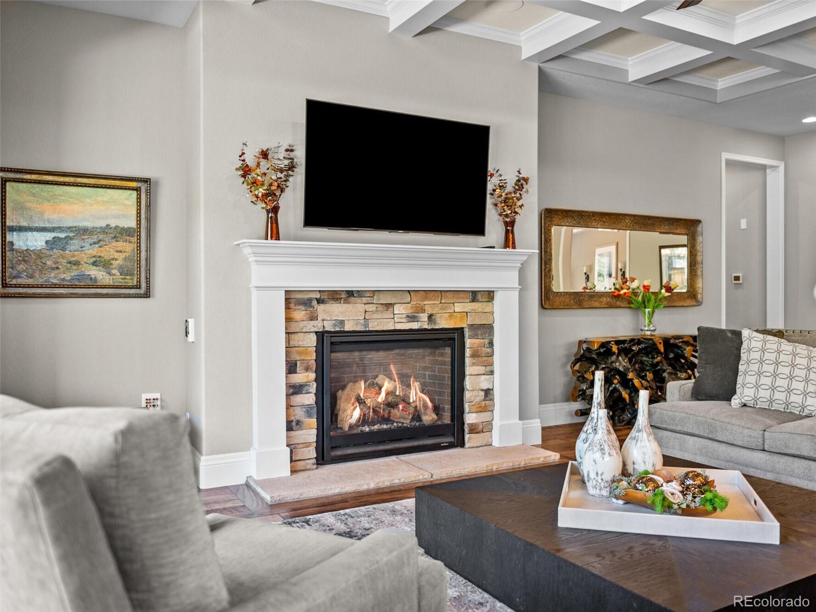 14945 Lyons Ridge Drive Morrison, CO 80465 - Photo 8 of 40 a living room with furniture a fireplace and a flat screen tv