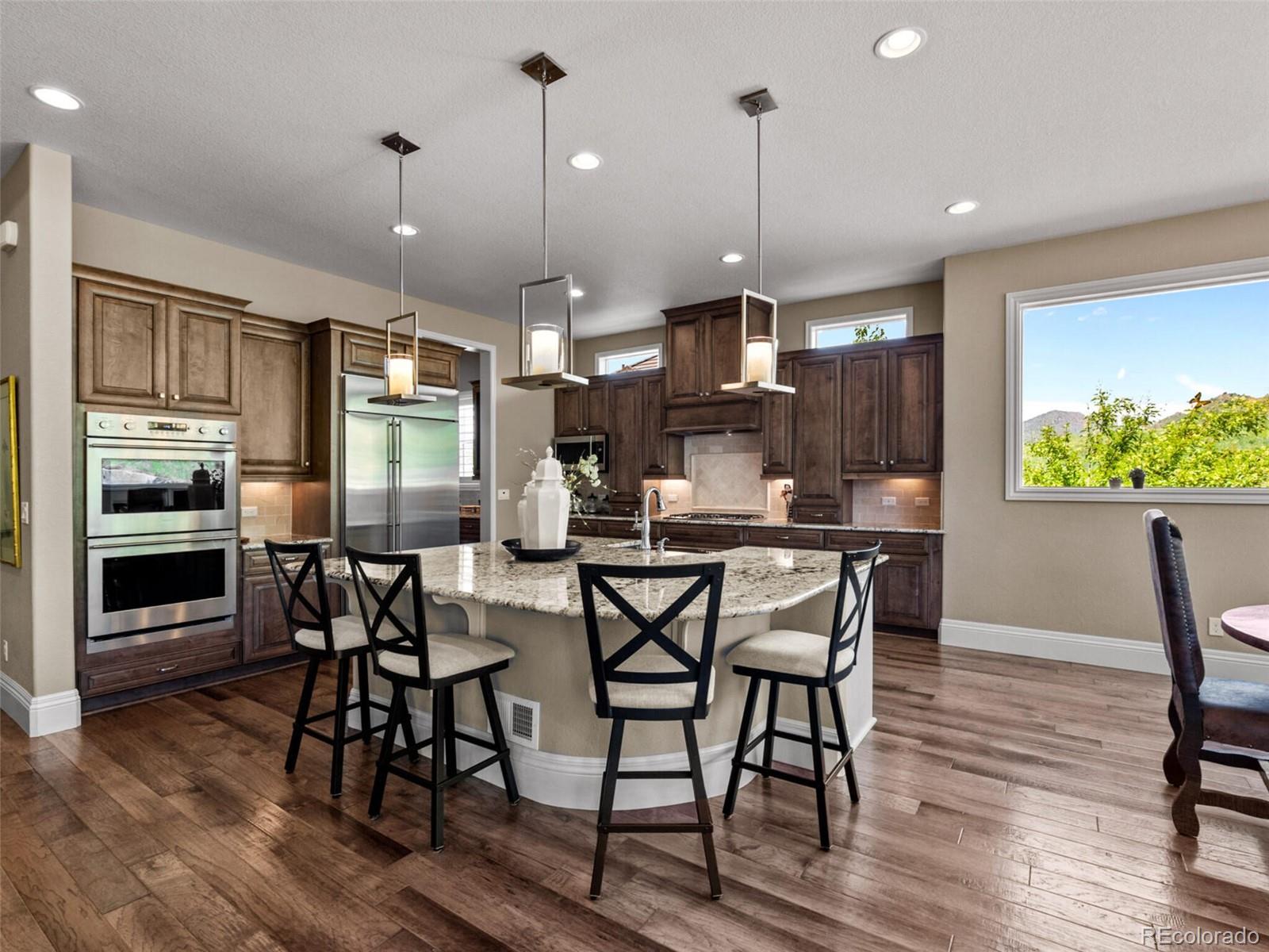 14945 Lyons Ridge Drive Morrison, CO 80465 - Photo 9 of 40 a view of a dining room with furniture window and wooden floor