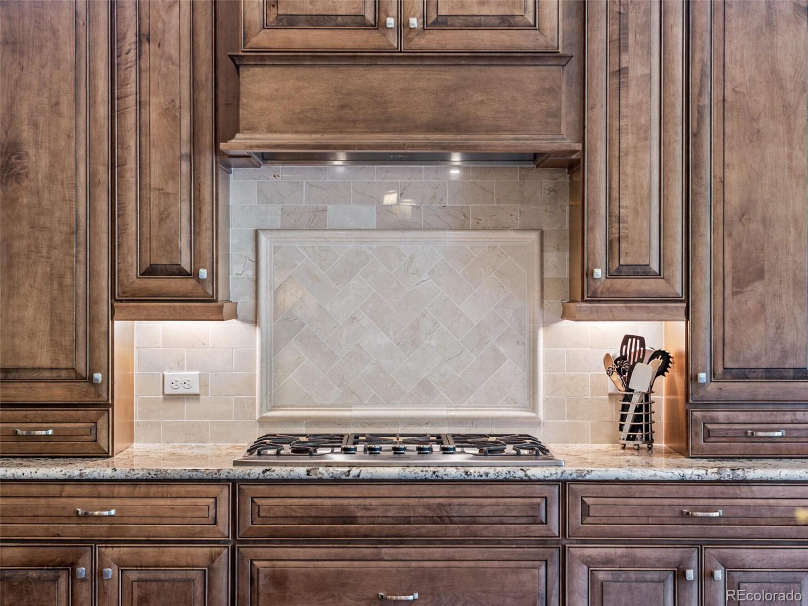 14945 Lyons Ridge Drive Morrison, CO 80465 - Photo 10 of 40 a stove top oven sitting inside of a kitchen
