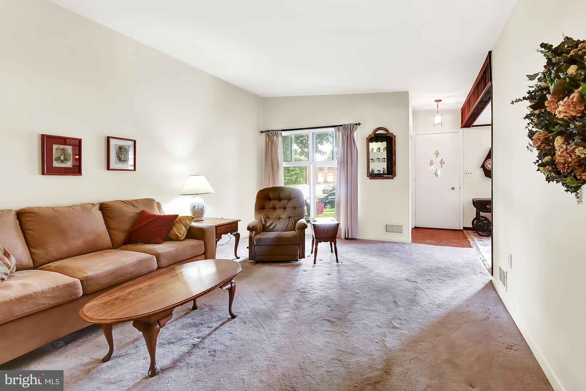 6827 Queens Ferry Road Baltimore, MD 21239 - Photo 3 of 29 Formal living room w carpet over wood floors