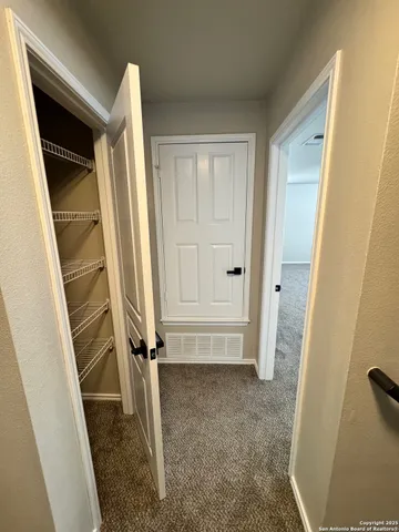 a view of a kitchen with cabinets and wooden floor
