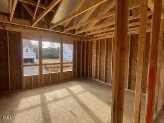 a view of a room with wooden floor and a window