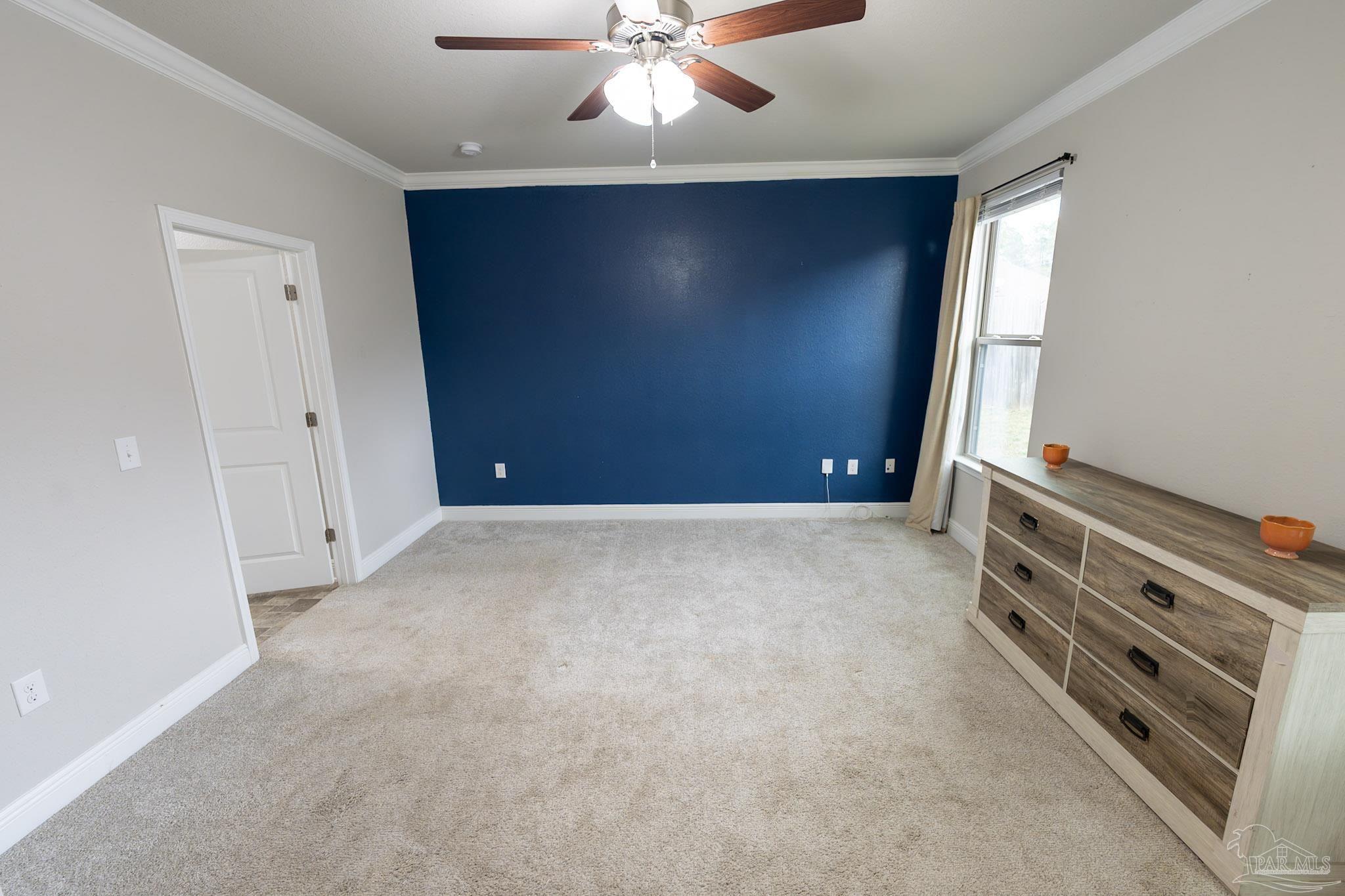 1060 Bretts Way Cantonment, FL 32533 - Photo 12 of 32 an empty room with windows and fan