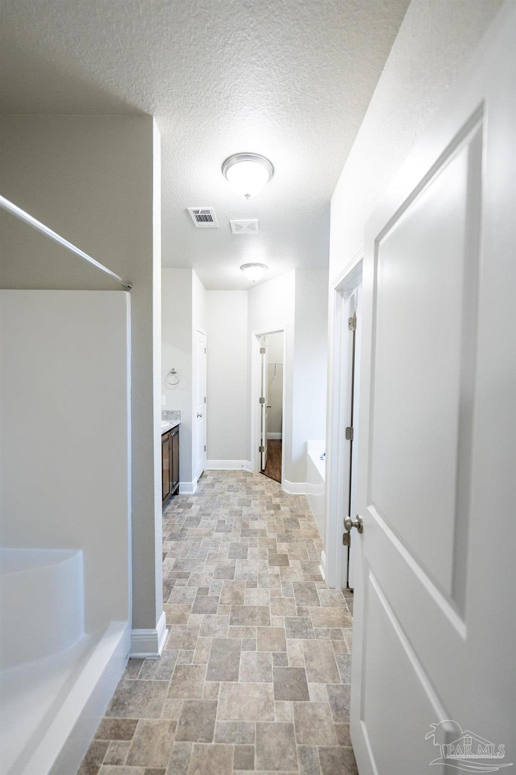 1060 Bretts Way Cantonment, FL 32533 - Photo 14 of 32 a view of a hallway with wooden shelves