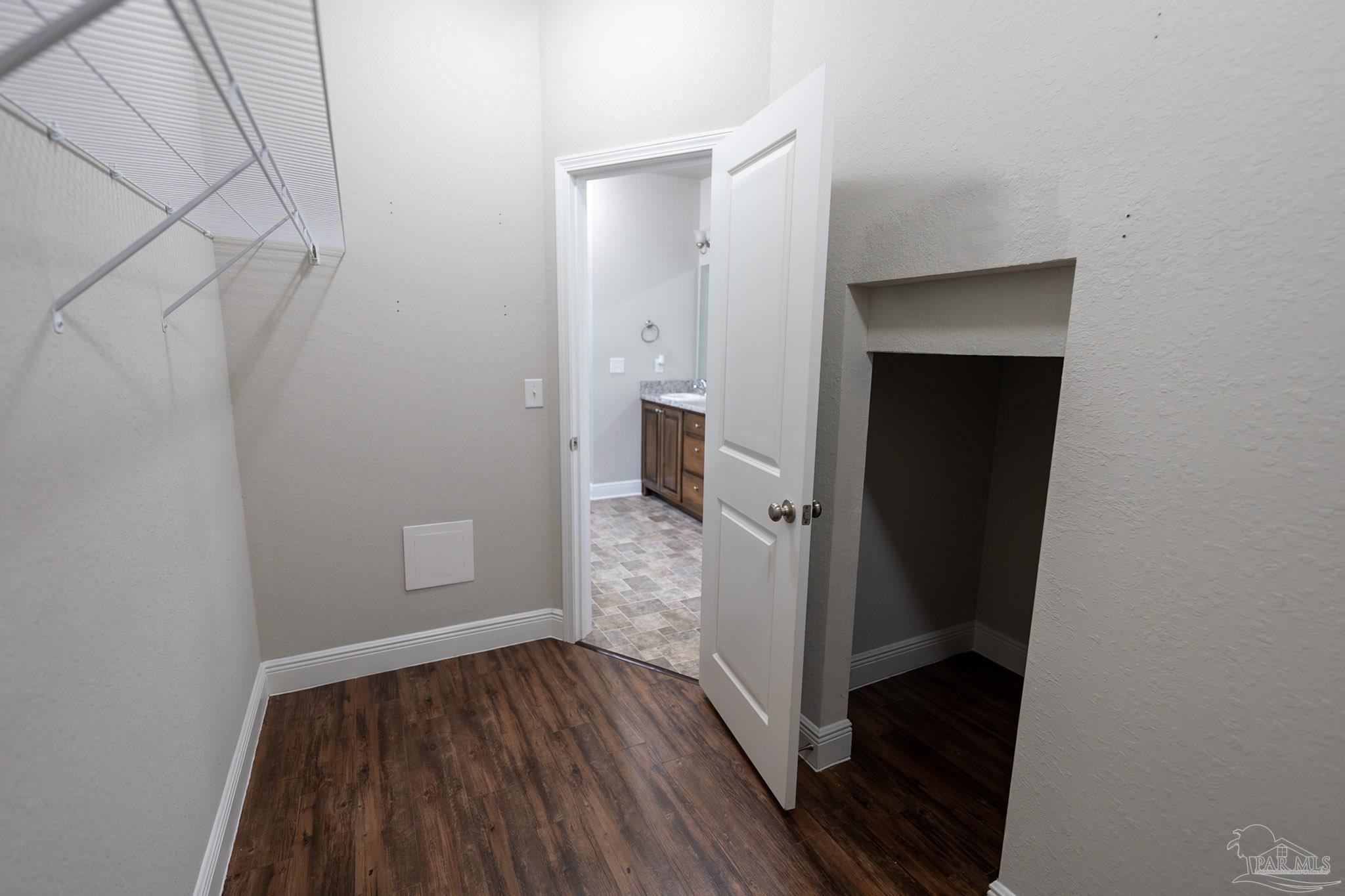 1060 Bretts Way Cantonment, FL 32533 - Photo 17 of 32 a view of a hallway view with wooden floor and staircase