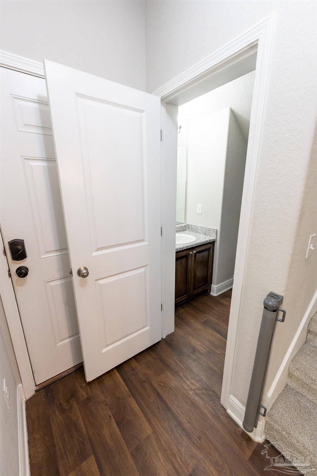 1060 Bretts Way Cantonment, FL 32533 - Photo 19 of 32 a view of walk in closet with wooden floor and white cabinet