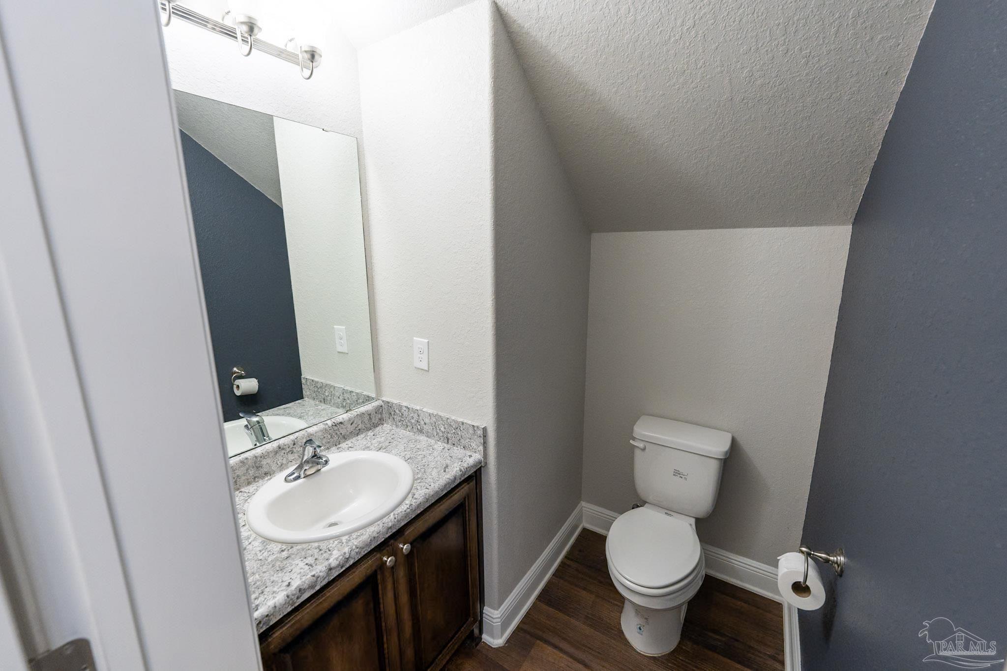 1060 Bretts Way Cantonment, FL 32533 - Photo 20 of 32 a bathroom with a granite countertop toilet and sink