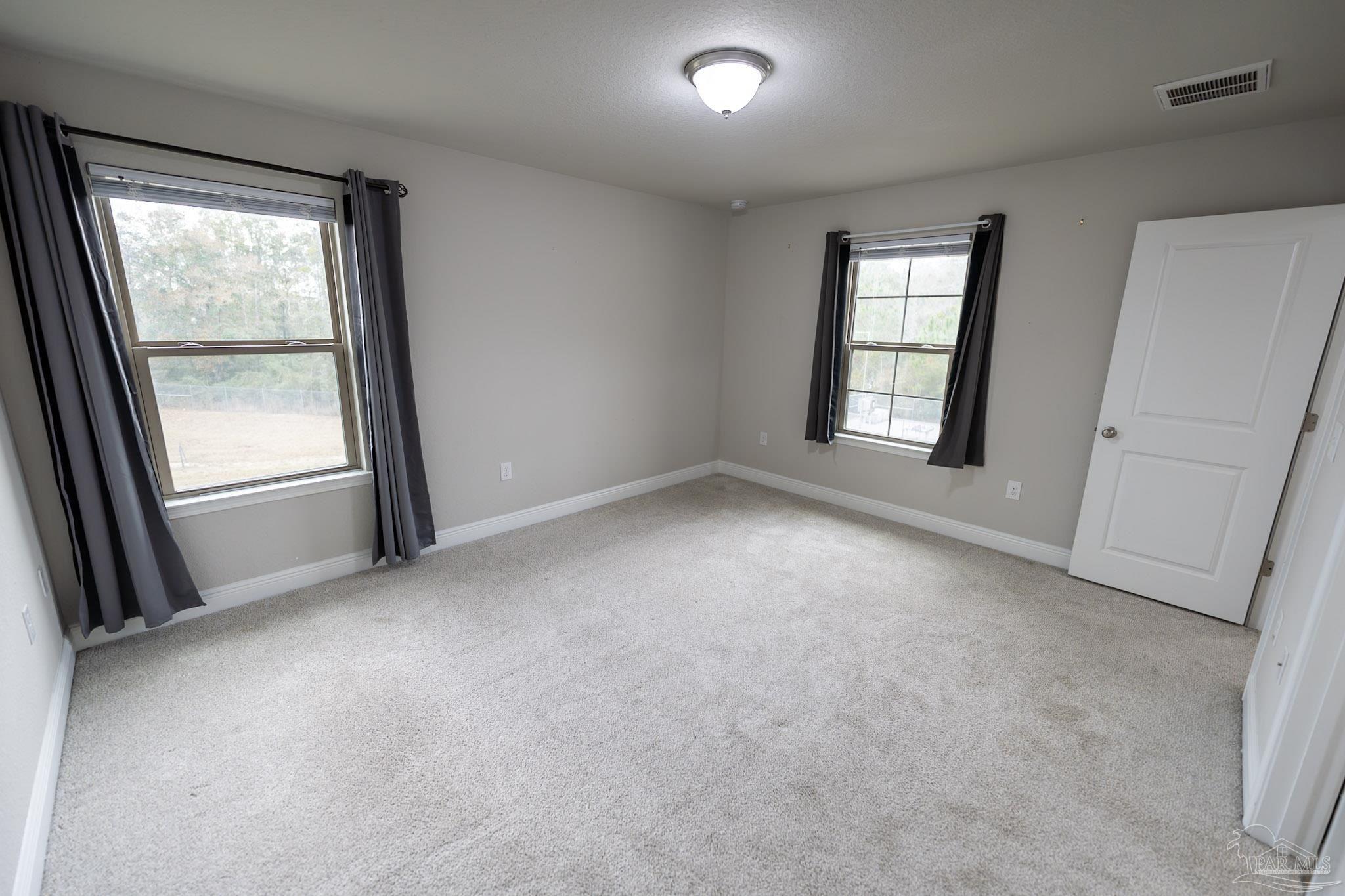 1060 Bretts Way Cantonment, FL 32533 - Photo 25 of 32 an empty room with windows