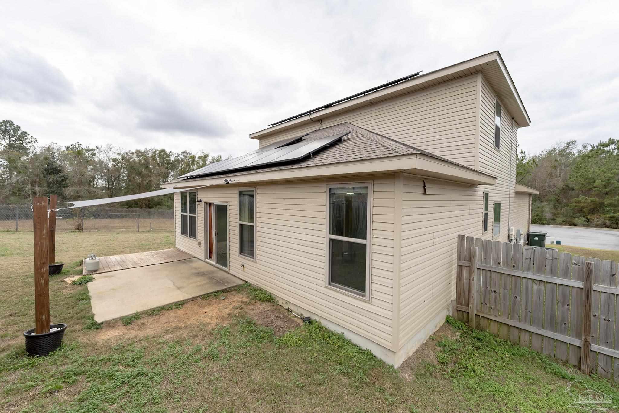 1060 Bretts Way Cantonment, FL 32533 - Photo 30 of 32 a view of a white house next to a yard