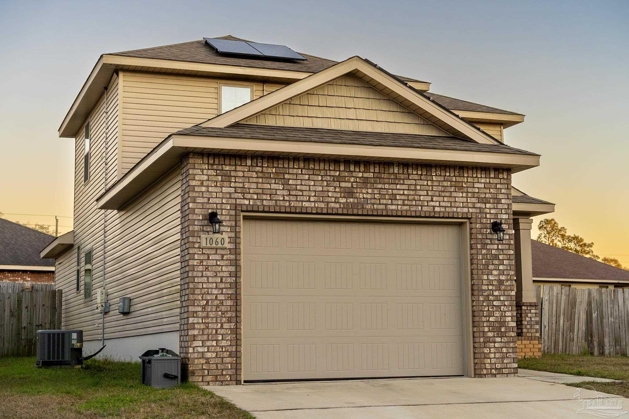 1060 Bretts Way Cantonment, FL 32533 - Photo 31 of 32 a front view of a house with garden