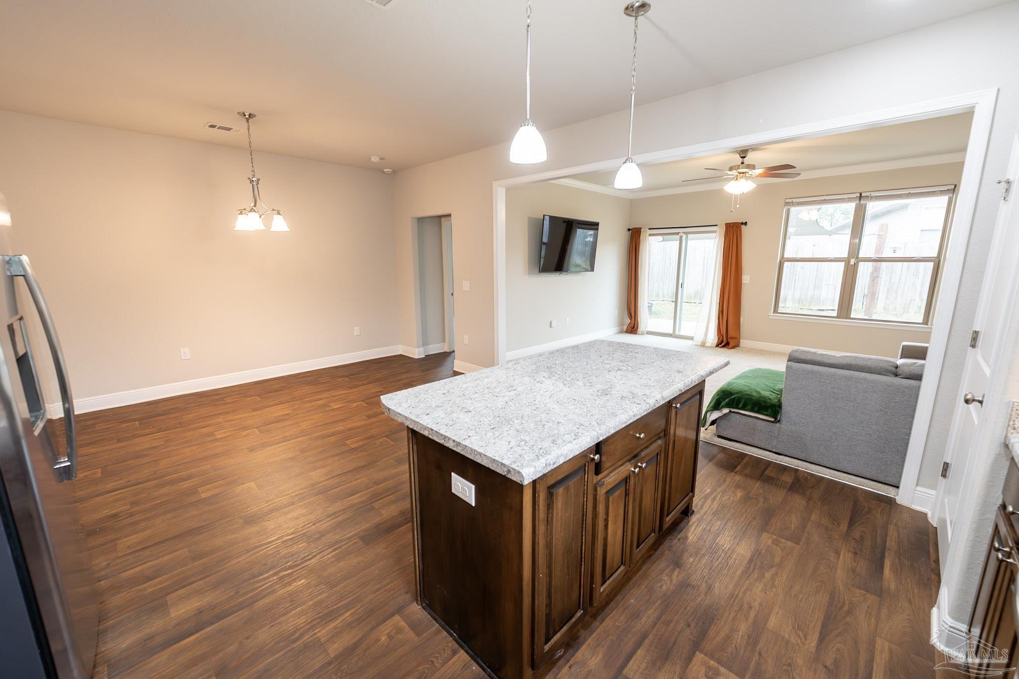 1060 Bretts Way Cantonment, FL 32533 - Photo 5 of 32 a kitchen with a stove and wooden floor