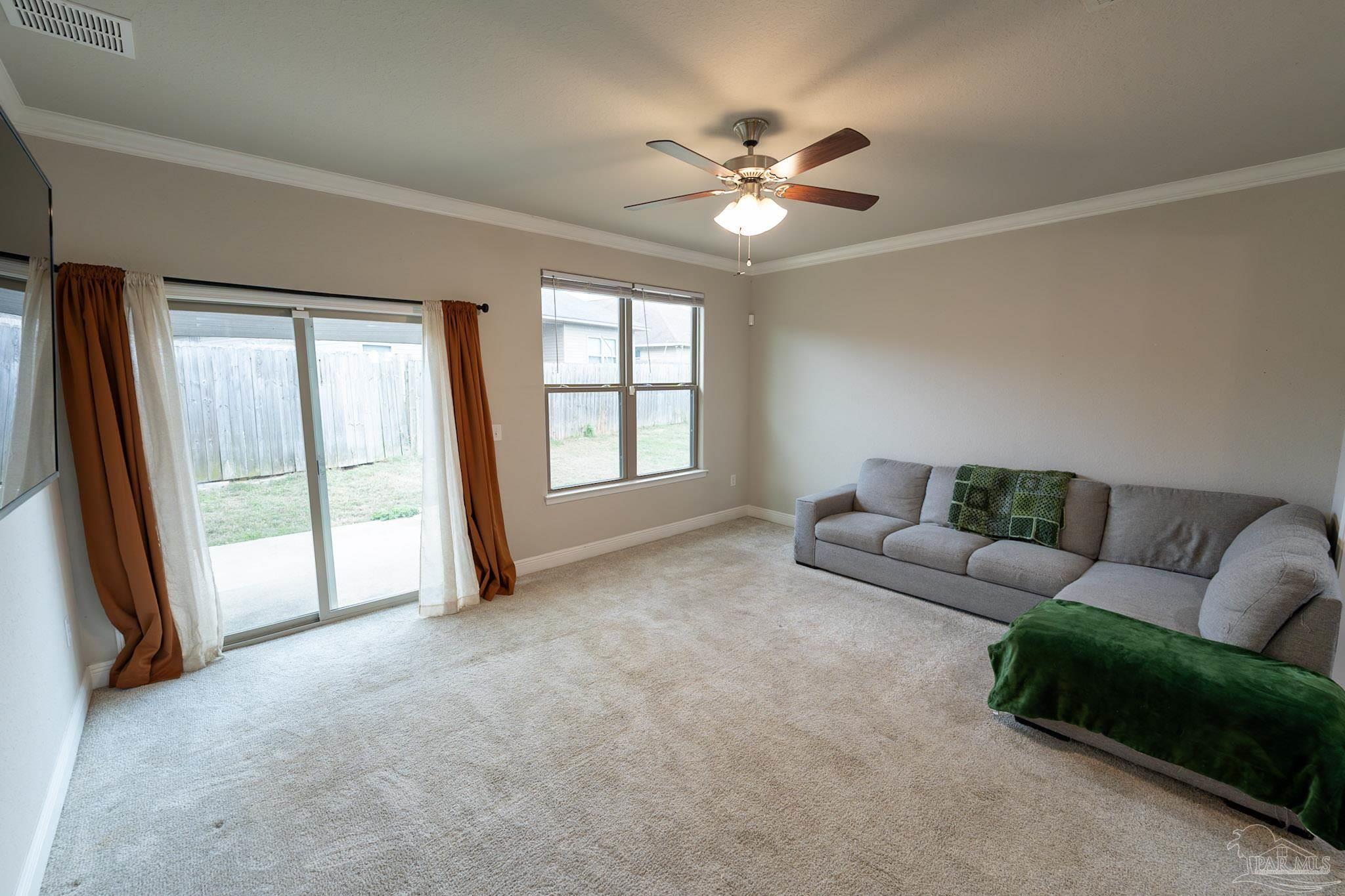 1060 Bretts Way Cantonment, FL 32533 - Photo 10 of 32 a living room with furniture and a large window
