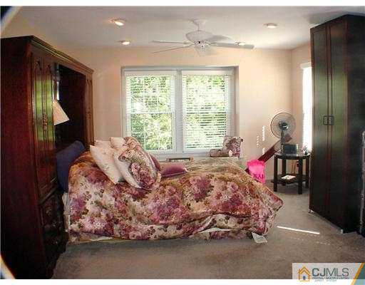 3901 Springbrook Drive Edison, NJ 08820 - Photo 7 of 10 a bed room with a bed and a window