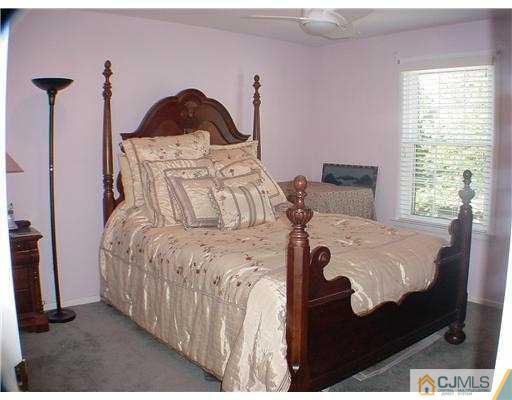 3901 Springbrook Drive Edison, NJ 08820 - Photo 8 of 10 a bed sitting in a bedroom next to a window